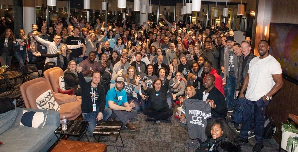 The 48in48 community gathered for an event opening, hands raised