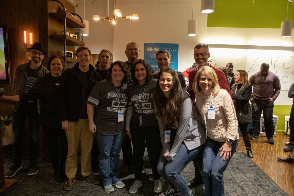 A sponsor team in matching 48in48 shirts at an event