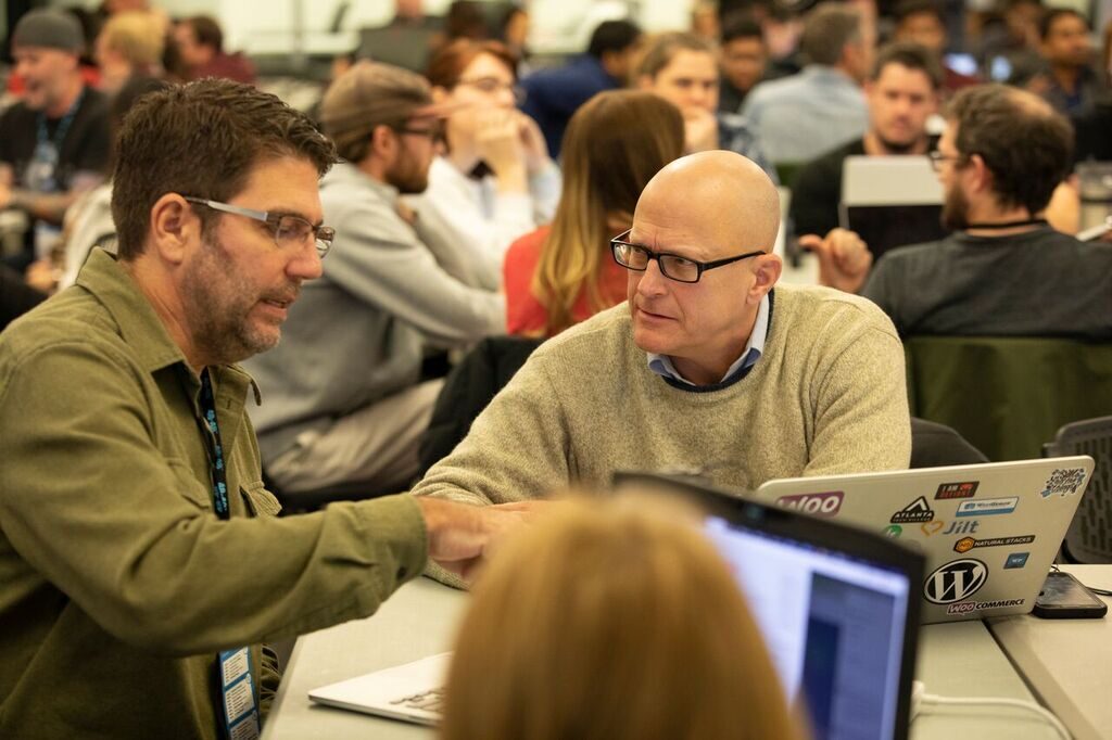 Two volunteers in conversation at a build event
