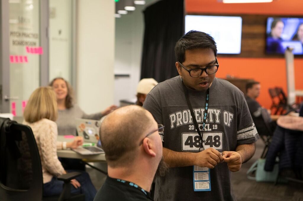 A volunteer wearing a 48in48 shirt at a build event