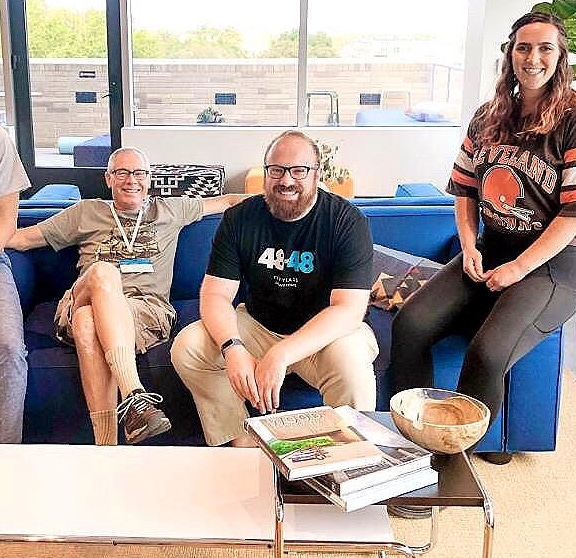Three volunteers sit on a couch and post for a photo during our 2019 Super Service Event in Miami