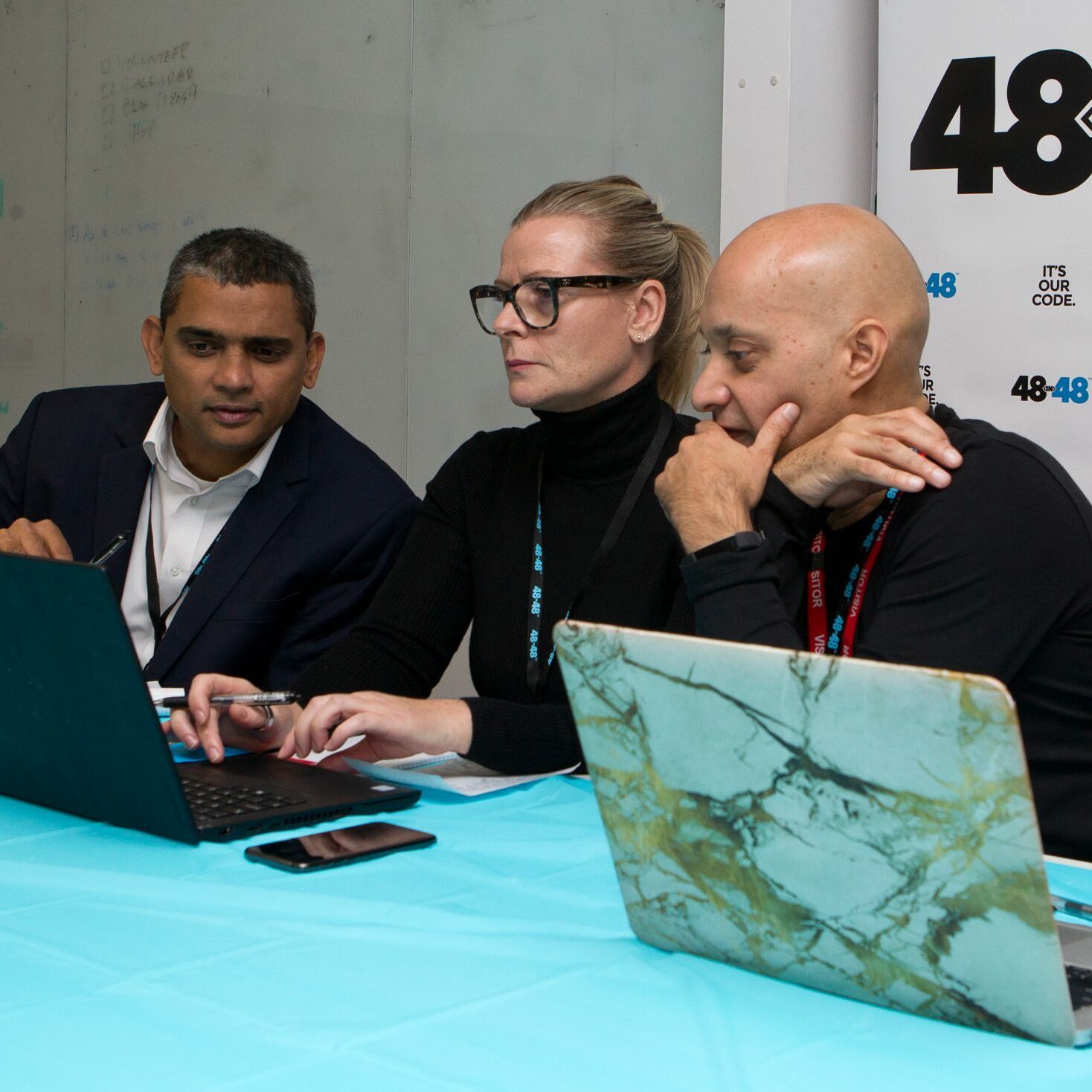 LONDON, UNITED KINGDOM - NOVEMBER 4:  Sumanth Rao (L), serving as a judge on behalf of Delta, pictured with fellow judges Andrea Moore (C) from Red Badger, and Girish Parekh (R), from Cisco, during the 48in48 event, sponsored by Delta, in London, UK, on November 4, 2018. 48in48 is an event which seeks to help 48 non-profit companies better serve their communities with 48 websites, all in 48 hours, and all with the help of volunteers.